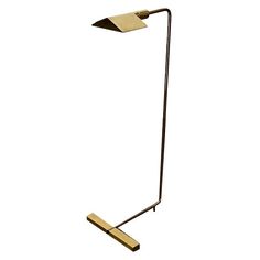 a floor lamp that is standing up against a white background with the light turned on