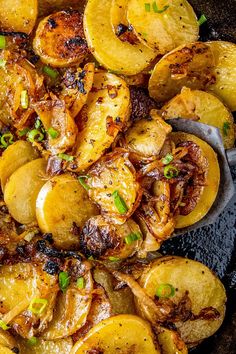 a white plate topped with fried potatoes and green onions