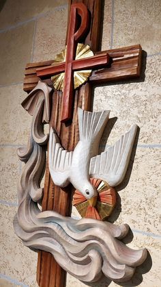 a wooden cross with a dove on it