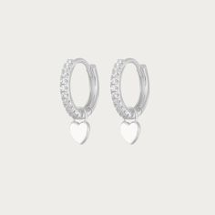 The Silver Gabby Heart Huggies are darling earrings crafted in sterling silver, featuring endearing heart-shaped accents in a classic huggie style. These earrings exude a timeless elegance with a touch of playful charm. Their sleek silver design makes them versatile, ideal for both casual and formal occasions, adding a delightful hint of love and sophistication to any ensemble. Available in various colours Hoop Size: 13mmx13mm Charm Size: 5mmx5mm Silver Plated Tarnish free / Water resistant 💧 Silver Heart Charm Huggie Earrings, Silver Huggie Earrings With Heart Charm, Silver Sterling Heart Charm Huggie Earrings, Silver Sterling Huggie Earrings With Heart Charm, Silver Huggie Earrings With Heart Charm For Gift, Silver Huggie Earrings With Heart Charm For Anniversary, Silver Sterling Heart-shaped Huggie Earrings, Silver Huggie Heart Charm Earrings, Silver Sterling Heart Shaped Huggie Earrings