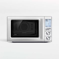 a silver microwave oven sitting on top of a white counter