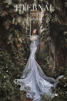 a woman is standing in the middle of some plants