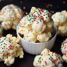 some white chocolate popcorn with sprinkles in a small bowl on a table