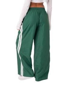 Edikted Fauna Nylon Track Pants Green Sporty Winter Bottoms, Sporty Green Bottoms For Winter, Sporty Green Winter Bottoms, Green Nylon Sports Pants, Green Nylon Sport Pants, Green Nylon Bottoms With Elastic Waistband, Trendy Green Nylon Pants, Nylon Wide-leg Pants For Streetwear, Sporty High-waisted Parachute Pants For Spring