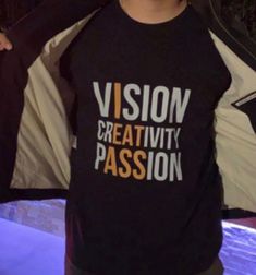 a man wearing a shirt that says vision creativity passion