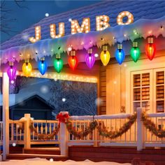 christmas lights are hanging from the roof of a house in front of a snow covered porch