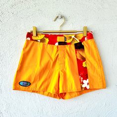 S p e c i f i c s . . . Label: Island X Hawaii  Tagged Size: 5 Approx. Fit: S  Color: Golden Yellow with Orange Hues // Reds // Browns // White Material: Water Resistant Material // Velcro Closure // Pocket Condition: Overall in Amazing New with Tags Vintage Condition Yellow Summer Swim Trunks With Built-in Shorts, Yellow Beach Shorts With Built-in Lining, Yellow Short Swim Trunks For Beach Season, Yellow Swim Trunks For Summer Beach, Yellow Swim Trunks For The Beach, Yellow Swim Trunks For Beach, Yellow Short Swim Trunks For Beach, Yellow Shorts For Poolside And Beach Season, Yellow Swimwear With Built-in Shorts For Vacation