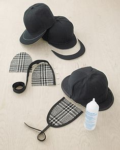 three hats, one black and one white are laid out on the floor next to each other