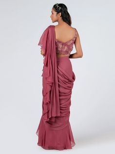 This is a two-piece mauve pre drape ruffle saree set from the Suruchi Parakh collection. The mauve ruffle saree in soft organza is paired with a crop top blouse. The georgette crepe blouse has padding and a back hook opening. There is beautiful floral print work all over the blouse. The hand-embroidered blouse enhances the pre draped saree in mauve color. Pre Draped Saree, Draped Saree, Ruffle Saree, Crepe Blouse, Drape Saree, Mauve Color, Saree With Blouse, Blouse Online, Crop Top Blouse