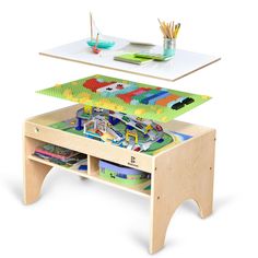 a wooden table with a toy train set on top of it and an open storage compartment underneath