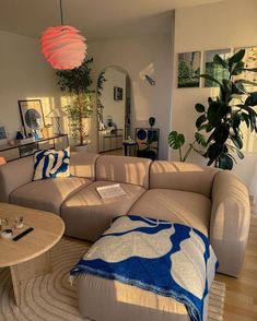 a living room filled with furniture and a plant