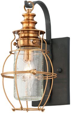 an old fashioned light fixture with a glass jar on it