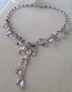 Inspired by the lavender fields in France, this necklace embraces the light violet colors of the flowers and the silvery white foliage surrounding the Exquisite Amethyst Pendant Necklace, Elegant Amethyst Dangle Necklaces, Elegant Amethyst Necklace For Healing, Elegant Handmade Amethyst Gemstones, Amethyst Crystal Necklaces With Gemstone Accents For Jewelry Making, Lavender Amethyst Briolette Jewelry, Amethyst Multi-stone Briolette Gemstones, Purple Briolette Gemstone Accented Jewelry, Amethyst Briolette Multi-stone Gemstones