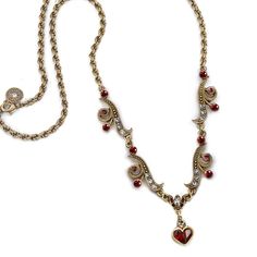 "This necklace features graceful contoured links, embellished with smoke and garnet red Swarovski crystal. From the wave link dangles a heart formed of pear shaped crystals. Double twist French rope chain. Burnished bronze finish. 16\" long plus 2\" extender. Made in our Los Angeles studio. Last photo shows the coordinating earrings which you can view here: https://www.etsy.com/listing/219278072 Contact us for bulk pricing and wholesale information." Red Victorian Necklace For Anniversary, Red Heart Beads Necklace For Wedding, Victorian Necklace For Formal Valentine's Events, Elegant Red Heart Beads Necklace, Cherry Chapstick, Double Twist, Outfit References, Necklace Ruby, Shaped Crystals