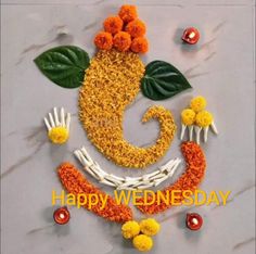 happy wednesday images with flowers and leaves in the shape of a smiley face on a marble surface