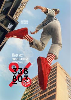 a man in red shoes jumping over a building