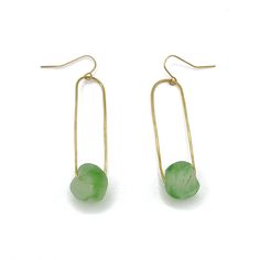 Handmade with love in our Uganda Sanctuary, the Jasmine drops are sure to catch the eye. Each brass wire is carefully sculpted around a beautiful seafoam green recycled glass bead from Ghana. Part of our Jasmine Collection, these earrings pair well with the entire collection. approx 2" in length Colors vary on each earring Made with recycled aqua glass beads and brass wire Sustainably handcrafted by artisans escaping human trafficking 100% of proceeds go to our non-profit, International Sanctuar Green Minimalist Brass Earrings, Minimalist Green Brass Earrings, Green Brass Earrings With Natural Stones, Green Wire Wrapped Czech Glass Earrings, Green Wire-wrapped Czech Glass Earrings, Green Wire Wrapped Long Drop Jewelry, Green Wire Wrapped Long Drop Earrings, Green Wire Wrapped Earrings With Czech Glass, Handmade Sea Glass Green Earrings