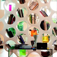 a table with some books on it in front of a book shelf filled with books