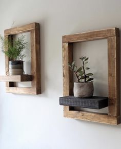 two square wooden shelves with plants on them and one holding a potted plant in it