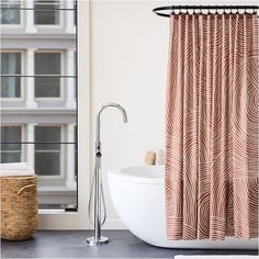 a bath tub sitting next to a window with a shower curtain in front of it