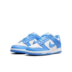 The Nike Dunk Low GS 'University Blue' is a sneaker that pays homage to its collegiate hardwood roots. This low-top shoe features a leather upper in a color-blocked design, with a crisp white base and pastel blue finish on the eyestay, Swoosh, and heel and forefoot overlays. Nike branding is featured on the tongue tag and heel tag, while the shoe sits on a durable rubber cupsole. The outsole provides performance-ready traction, making this sneaker perfect for big kids who want a stylish and functional sneaker. Unc University, Customized Shoes, Trendy Shoes Sneakers, Blue Jordans, Nike Models, Cute Nike Shoes, Fresh Shoes, Hype Shoes, Cute Nikes