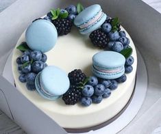 a cake decorated with macaroons and blueberries