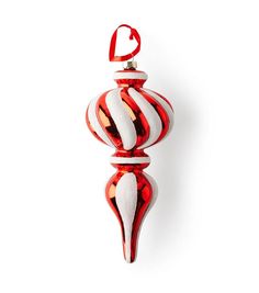 a red and white glass ornament hanging from a hook on a wall in front of a white background