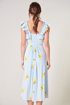 Perfect picnic attire. Yellow floral clusters against a blue picnic gingham shape the classic Milo Dress. Ruffle details create a flouncy strap and line a square neckline. A fitted bodice falls into an A line midi skirt. The back entails more smocking along with a shirring at the waist. Pair the look with simple accessories and sneakers to dress the look down.- Ruffle details- A line- Smocked back- Shirred- Color: Blue YellowSize + Fit - Model is 5'8" and wearing size XS- Measurements taken from Picnic Attire, Picnic Gingham, Blue Picnic, A Line Midi Skirt, Simple Accessories, Perfect Picnic, Blue Gingham, Floral Ruffle, Blue Midi Dress