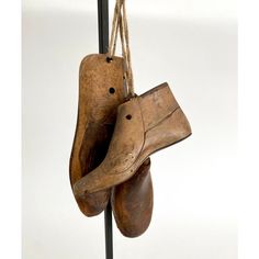 two wooden shoes hanging from a pole