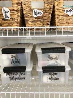 three plastic containers with labels on them sitting in a refrigerator next to other bins