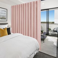 a bedroom with pink curtains and white bedding in front of a sliding glass door