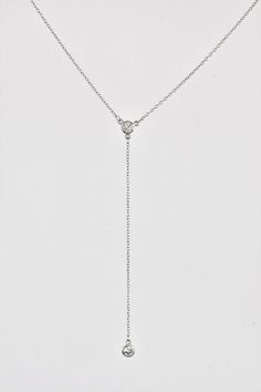 DETAILS MATERIAL 925 Sterling Silver Rhodium plated 18K Gold plated (1micron) SIZE: Zircon CHARM - approx. 5mm/0.20in Zircon drop - approx. 8.5cm/3.5in CHAIN: Trace chain with extender can be worn at 15in/38cm, 16in/41cm and 17in/43cm DESCRIPTION: Minimalist and timeless, this dainty cz lariat necklace is the perfect finish to your outfit. The necklace features slender chain in a sleek Y shape with 2 mini cubic zirconia charms. The zircon drop is approx 8.5cm/3.5 inches. The necklace fastens wit Dainty Sterling Silver Backdrop Necklace With Adjustable Chain, Dainty Sterling Silver Backdrop Necklace With Delicate Chain, White Gold Drop Necklace With Adjustable Chain, White Gold Lariat Necklace With Adjustable Long Drop Chain, Silver Drop Necklace With Adjustable Chain, Fine Jewelry Sterling Silver Drop Necklace With Clavicle Chain, Silver Lariat Necklace With Delicate Chain For Anniversary, Dainty White Gold Lariat Necklace With Delicate Chain, Sterling Silver Lariat Diamond Necklace With Adjustable Chain