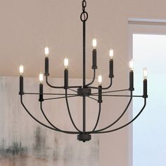 a black chandelier with eight lights hanging from it's center and two sides