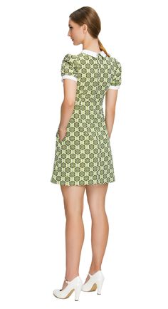 SEASON'S END SALE! LImited quantity left. Fitted sixties style, shades of navy blue, a-line dress; a versatile piece suitable for both work and play. This dress features a charming floral pattern in various shades of green, exuding a delightful retro vibe. The style features a white bib offset by a 4-button-detailed tab, slightly puffed short sleeves, and functional side pockets, adding a touch of timeless elegance and practicality to the ensemble. To suit your style, this dress is also availabl Retro A-line Mini Dress For Work, Green Mini Dress For Summer Workwear, Green Cotton Mini Dress For Work, Fitted Mod Mini Dress For Work, Retro Knee-length Workwear Dresses, Mod Spring Workwear Dresses, Mod Green A-line Dress, Mod Mini Dress For Work, Mod Mini Dress With Short Sleeves