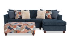 a blue couch and ottoman with pillows on it