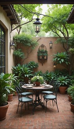 an outdoor dining area with potted plants