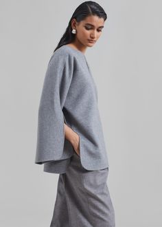 Color: Grey Melange Midweight knitted structure Relaxed fit V neckline Split dolman sleeves Slip on style Unlined 100% Wool Dry Clean By Malene Birger. Imported Elegant Oversized Sweater For Daywear, Oversized Elegant Sweater For Daywear, Elegant V-neck Textured Knit Outerwear, Elegant Wool Tops With Textured Knit, Elegant Textured Knit Wool Top, Oversized Textured Knit Tops For Work, Elegant Oversized V-neck Top, Elegant Fall Sweater With Batwing Sleeves, Textured Knit Wool Top For Workwear