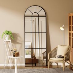 a living room filled with furniture and a tall mirror on the wall next to a table