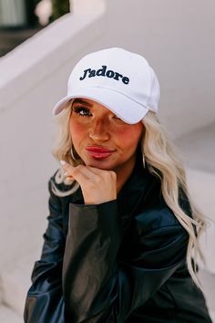 - This adorable cap will step up your casual style game! - A rounded bill - An adjustable back - Black colored 'J'adore' embroidery on the front White Curved Visor Hat With Letter Print, White Dad Hat With Letter Print And Curved Visor, White Baseball Cap With Letter Print And Curved Visor, Trendy White Baseball Cap With Embroidered Logo, White Snapback Visor Hat With Letter Print, White Letter Print Snapback Visor Hat, White Letter Print Visor Snapback Hat, White Letter Print Baseball Cap For Streetwear, White Casual Fitted Hat With Letter Print