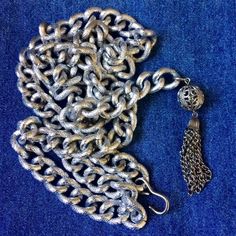 Well made lightweight aluminum chain belt/necklace. Textured silver tone links measure approx. 1/2 inch by 3/4 inch. Chain measures approx. 35 inches long with a 2 3/4 inch filigree ball and tassel on one side, j hook on other side. Fully adjustable. Can be worn a number of ways.Condition is very good vintage. As found. I leave decision of cleaning up to buyer. Belt Necklace, Tassel Belt, Chain Belts, Chain Belt, May 5, Multi Strand, Vintage Pink, Chains Necklace, Pink And Orange