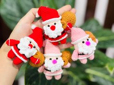 small crocheted santa claus and other christmas decorations in someone's hand,