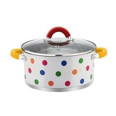 a white pot with colorful polka dot designs on the lid and handles, holding a wooden handle