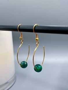 Fish hook earrings with emerald green colored premium glass bead, gold plated earring hooks Adjustable Gold Jewelry With Fish Hook, Gold Beaded Dangle Earrings With French Hook, Gold Beaded Earrings With French Hook As Gift, Elegant Beaded Earrings With French Hook As Gift, Elegant Jewelry With Fish Hook For Gift, Gold Jade Earrings With Ear Wire, May Birthstone Drop Earrings With Ear Wire, Gold Dangle Earrings With Fish Hook, Gold Drop Earrings With Fish Hook