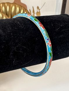 This beautiful hand painted bangle bracelet has a blue enamel with a beautiful floral design.  In excellent vintage condition with little to no signs of wear.  Internal diameter of approx. 2.50 inches and a width of .25 inches  Note: this is for a petite wrist, please measure wrist before purchase.  If you like this listing, please take a look at my shop for more vintage jewelry! https://etsy.me/340ixDv You will receive the exact item pictured! Please review the photos and description before buy Vintage Blue Enamel Bracelets, Blue Enamel Bracelet Jewelry, Blue Enamel Bangle Bracelet, Blue Enamel Bangle As A Gift, Blue Enamel Bangle Gift, Handmade Enamel Bangle, Blue Enamel Bangle, Blue Enamel Bangle Perfect As A Gift, Adjustable Hand Painted Blue Bracelet