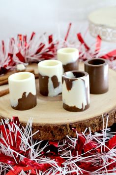 chocolate dipped marshmallows sitting on top of a wooden board