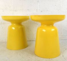 two yellow stools sitting next to each other