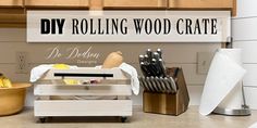 a wooden crate with utensils in it and a sign that says diy rolling wood crate