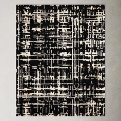 a black and white rug with an abstract design on the bottom, it is made out of