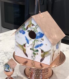 a bird house sitting on top of a metal stand