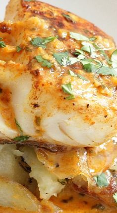 a close up of food on a plate with parmesan cheese and herbs in it